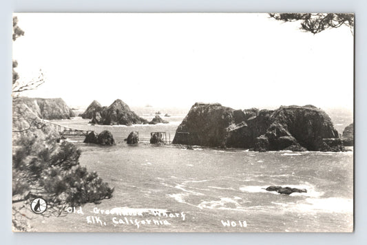Elk California RPPC showing the remains of Greenwood Wharf with offshore rock formations along the Mendocino County coastline.