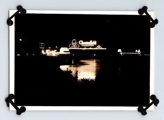 Atlantic City New Jersey Chesterfield Cigarettes neon sign reflected in water nighttime boardwalk scene 1920s photograph