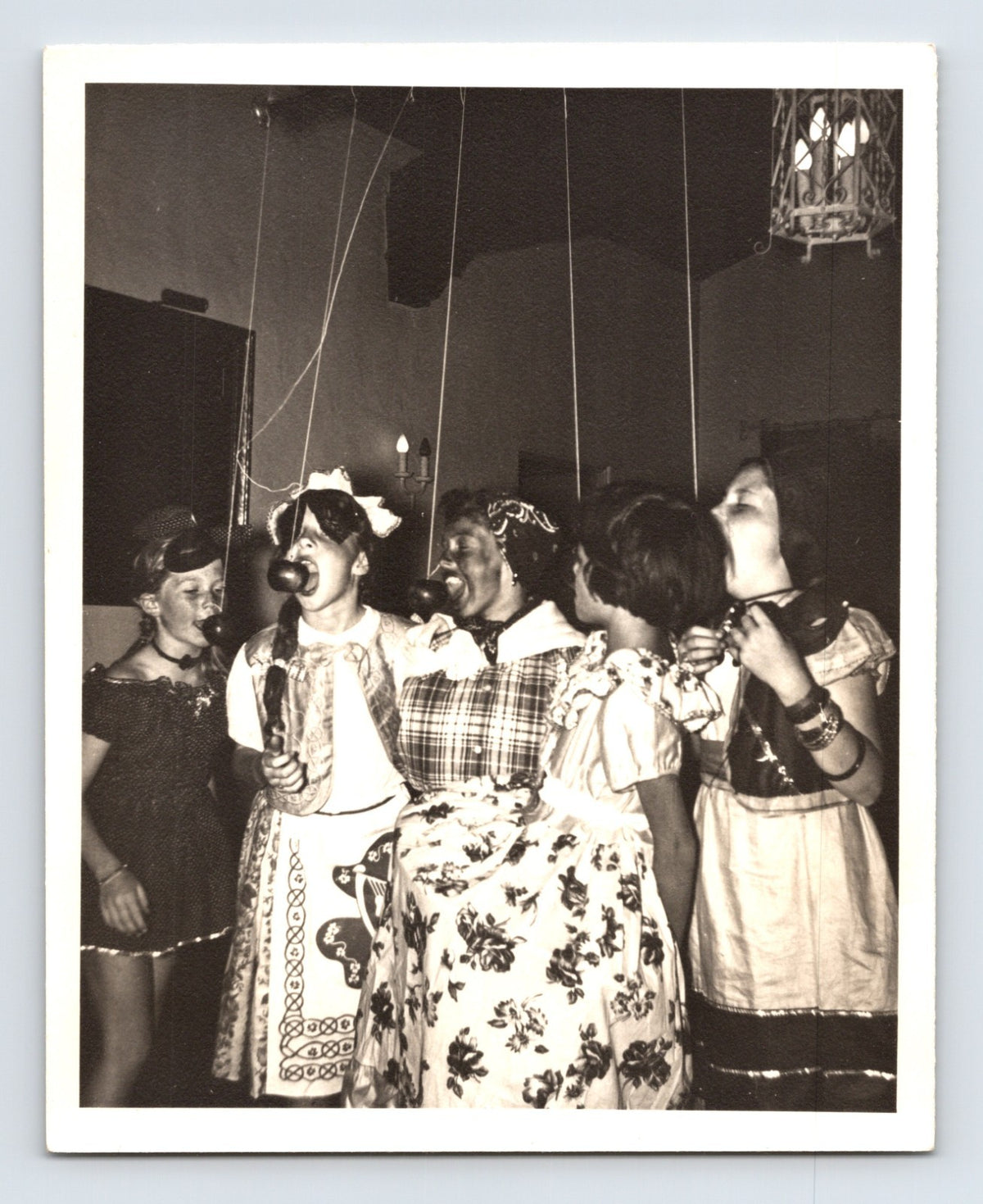 Girls Halloween bobbing for apples party dresses suspended apples game 1960s snapshot photo 5 x 4
