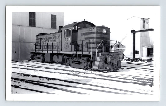 Genesee Wyoming railroad switcher locomotive in snow 1950s black and white train yard photo