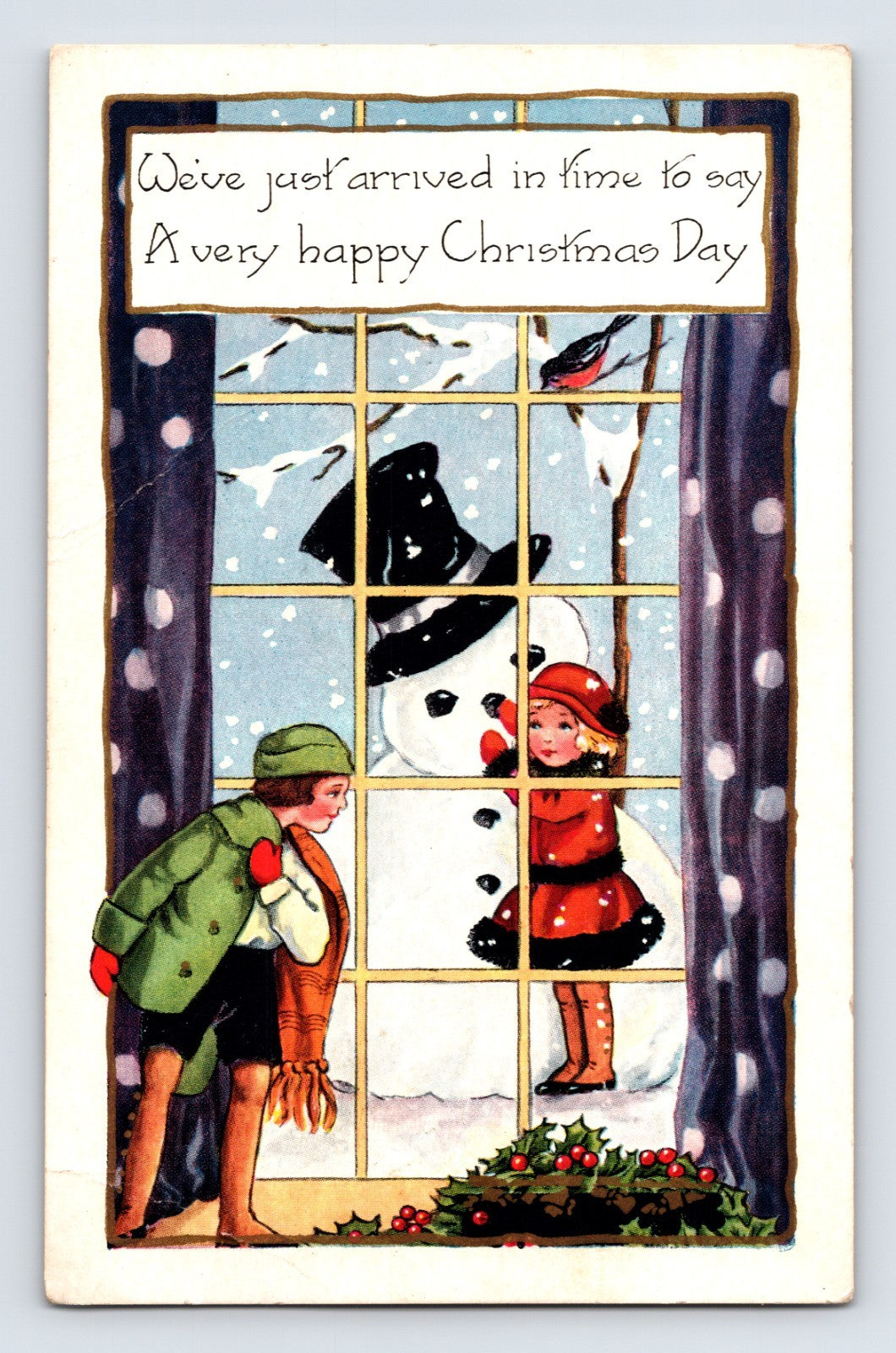 Children building snowman outside snowy window with holly decoration and holiday verse on colorful Christmas postcard from the early twentieth century.