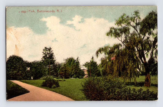 1912 Buttonwoods Rhode Island park postcard showing landscaped grounds with walking path trees and open green lawn