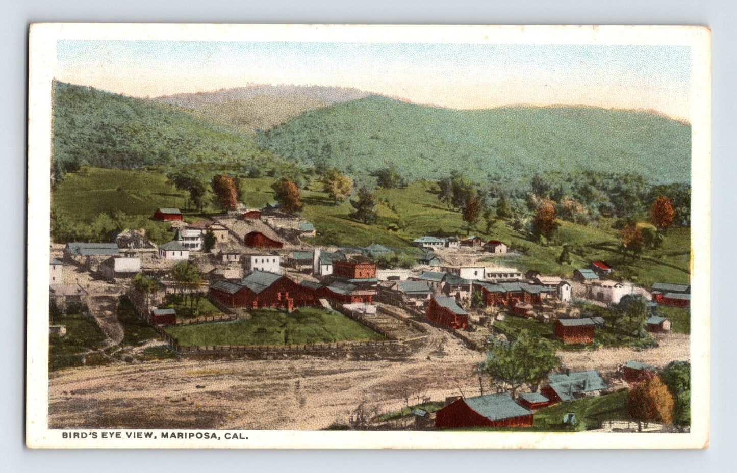 Birds eye view of downtown Mariposa California with hillside backdrop 1930s unposted postcard