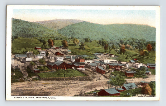 Birds eye view of downtown Mariposa California with hillside backdrop 1930s unposted postcard