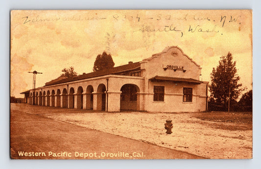 Western Pacific Depot in Oroville California showing long arched arcade train station building with street frontage and sepia photographic detail