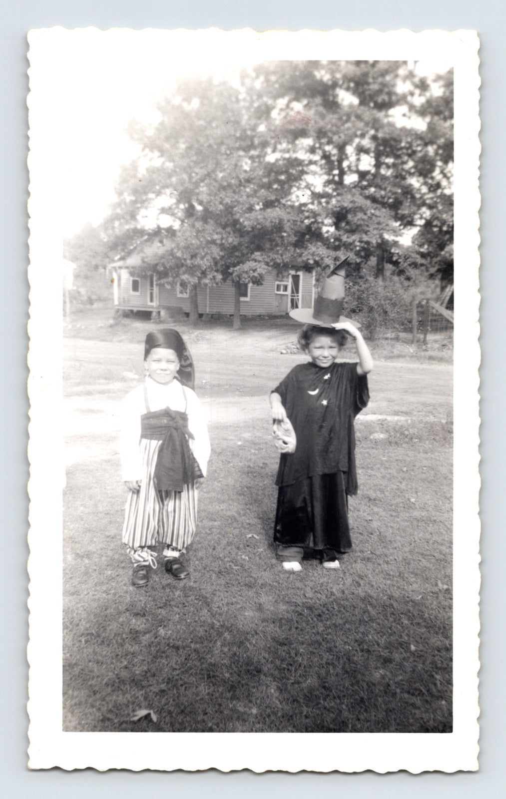 Halloween children witch costume striped outfit yard rural house 1940s snapshot
