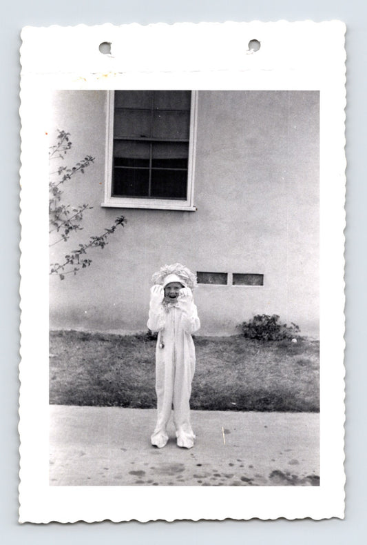 Halloween photo child costume lion suit outdoor sidewalk 1960s snapshot kid in animal costume yard scene 5 x 3.25