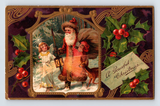 Santa Claus with lantern beside angel child and deer framed by holly border on embossed 1908 Christmas postcard.