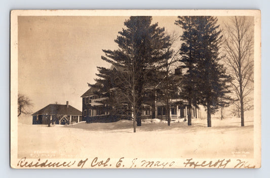 Sepia winter view of Mayo residence framed by tall pine trees in Dover Foxcroft Maine 1913