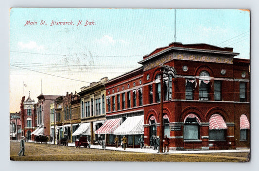 Bismarck North Dakota Main Street downtown storefronts early 1900s horse wagon street scene postcard
