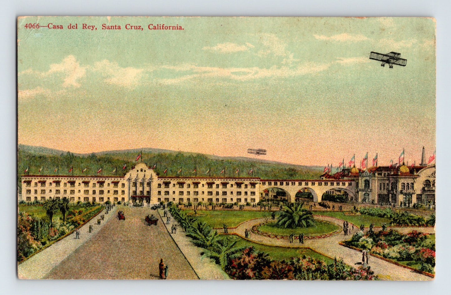 Casa Del Rey Hotel Santa Cruz California with gardens and early airplanes overhead vintage postcard view