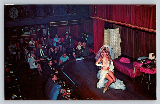New Orleans Louisiana Sho Bar Club postcard showing burlesque stage performance with seated audience 1960s interior scene