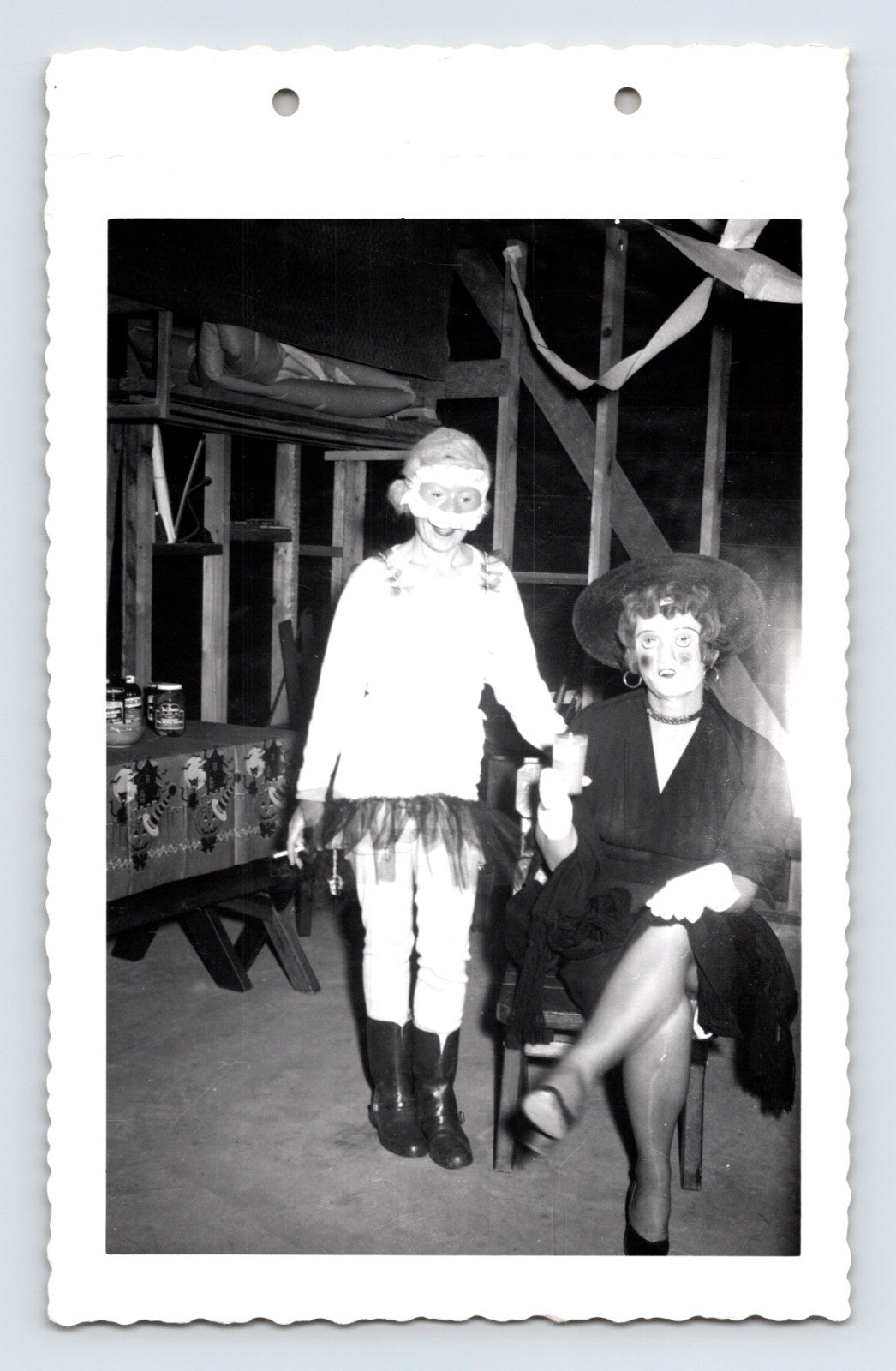 Halloween costume party child mask and woman witch costume indoor 1950s photo
