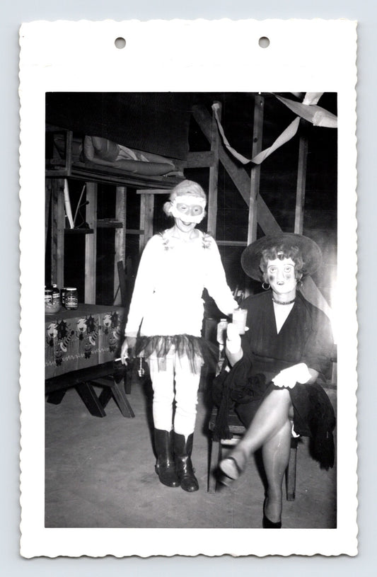 Halloween costume party child mask and woman witch costume indoor 1950s photo