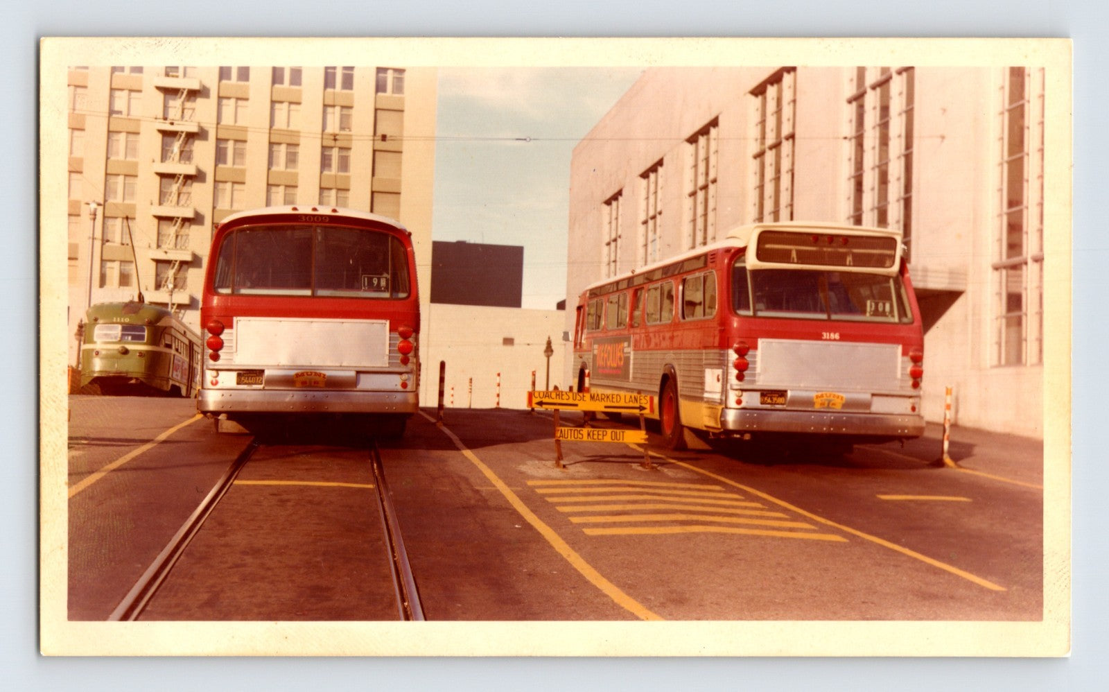 Detroit Michigan Muny DSR buses 3009 and 3186 at terminal with track lane markings color photo 1960s