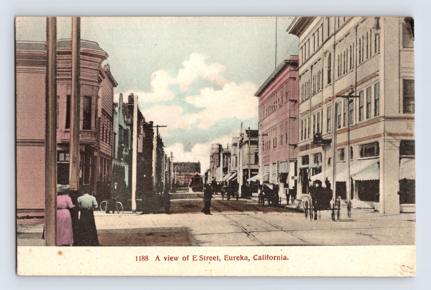 Eureka California E Street downtown 1910s hand-colored postcard showing early storefronts, pedestrians, and streetcar tracks