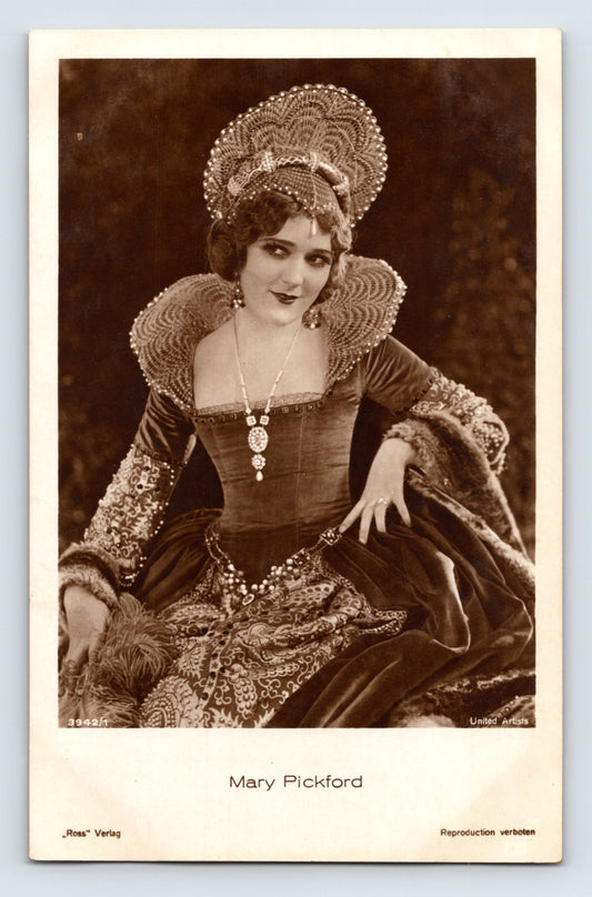 Sepia studio portrait postcard of Mary Pickford seated in elaborate period costume with ornate headdress and embroidered gown, Ross Verlag imprint visible below image.