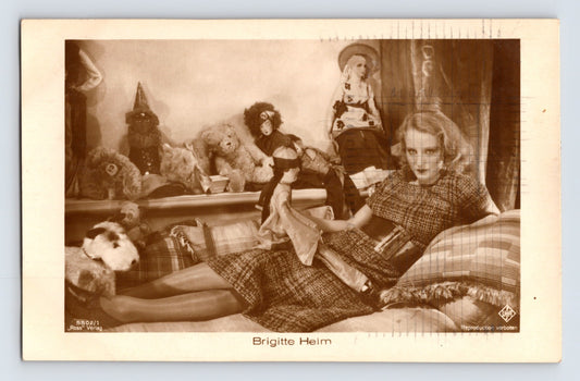 Brigitte Helm 1930s RPPC postcard silent film actress posed with dolls UFA studio portrait