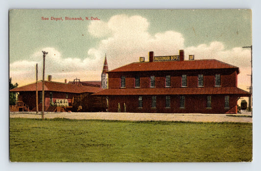 Bismarck North Dakota Soo Railroad passenger depot brick station building with platform and freight area, early 1910s postcard view