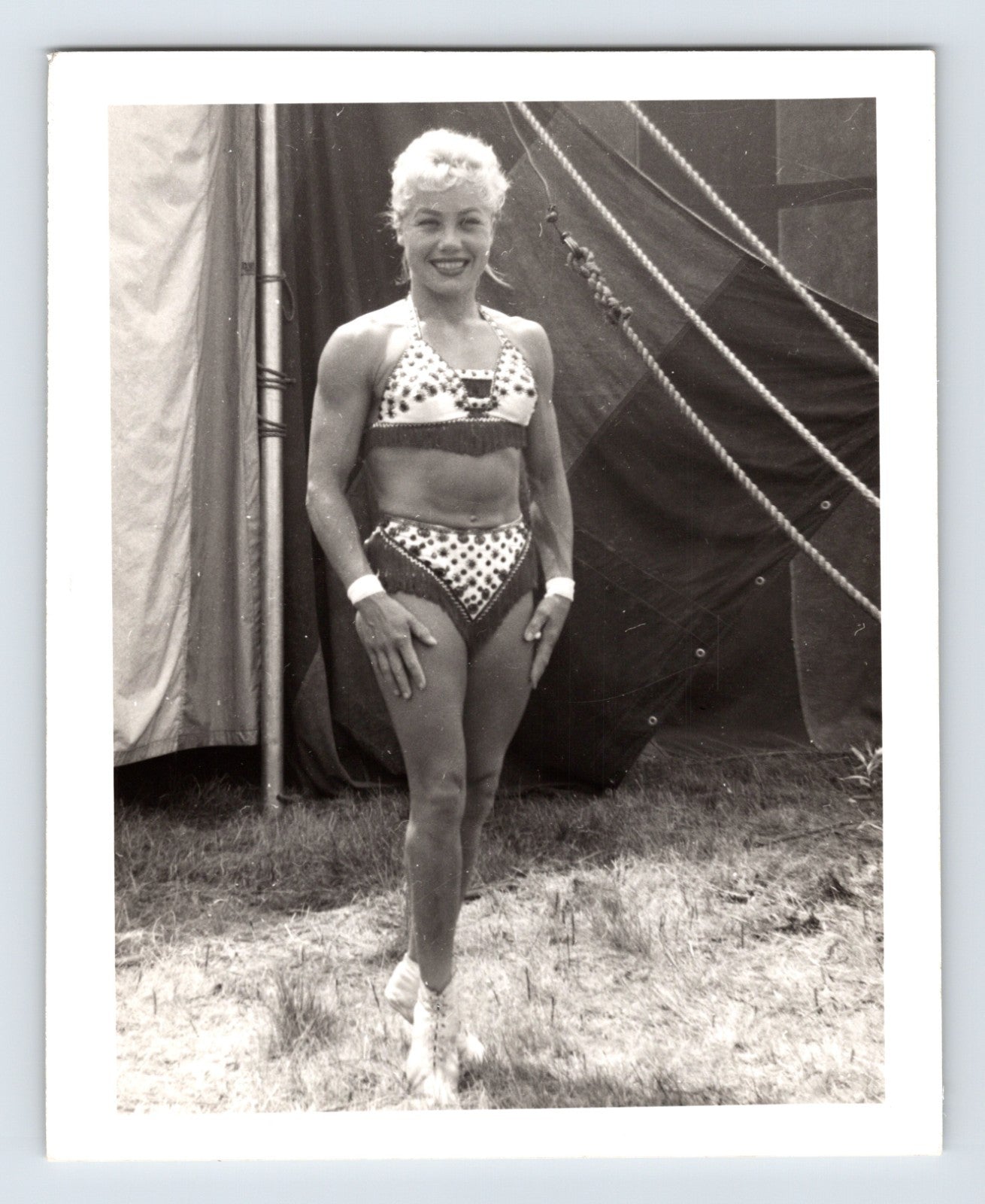 Mills Bros Circus showgirl performer posing beside big top tent ropes 1964 candid photograph