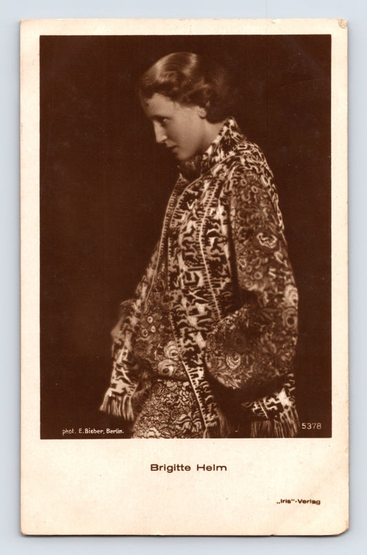 1930s postcard portrait of silent film actress Brigitte Helm wearing an ornate patterned shawl in a dramatic studio photograph published by Ross Verlag.