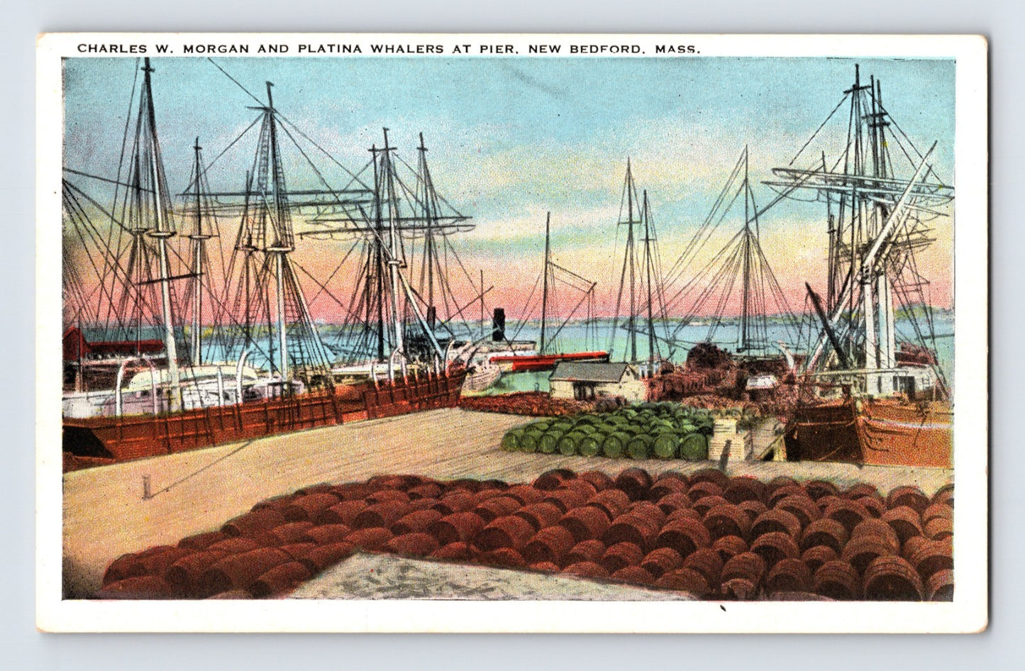 New Bedford whaling pier with Charles W Morgan and Platina whalers docked barrels stacked in foreground harbor sunset scene