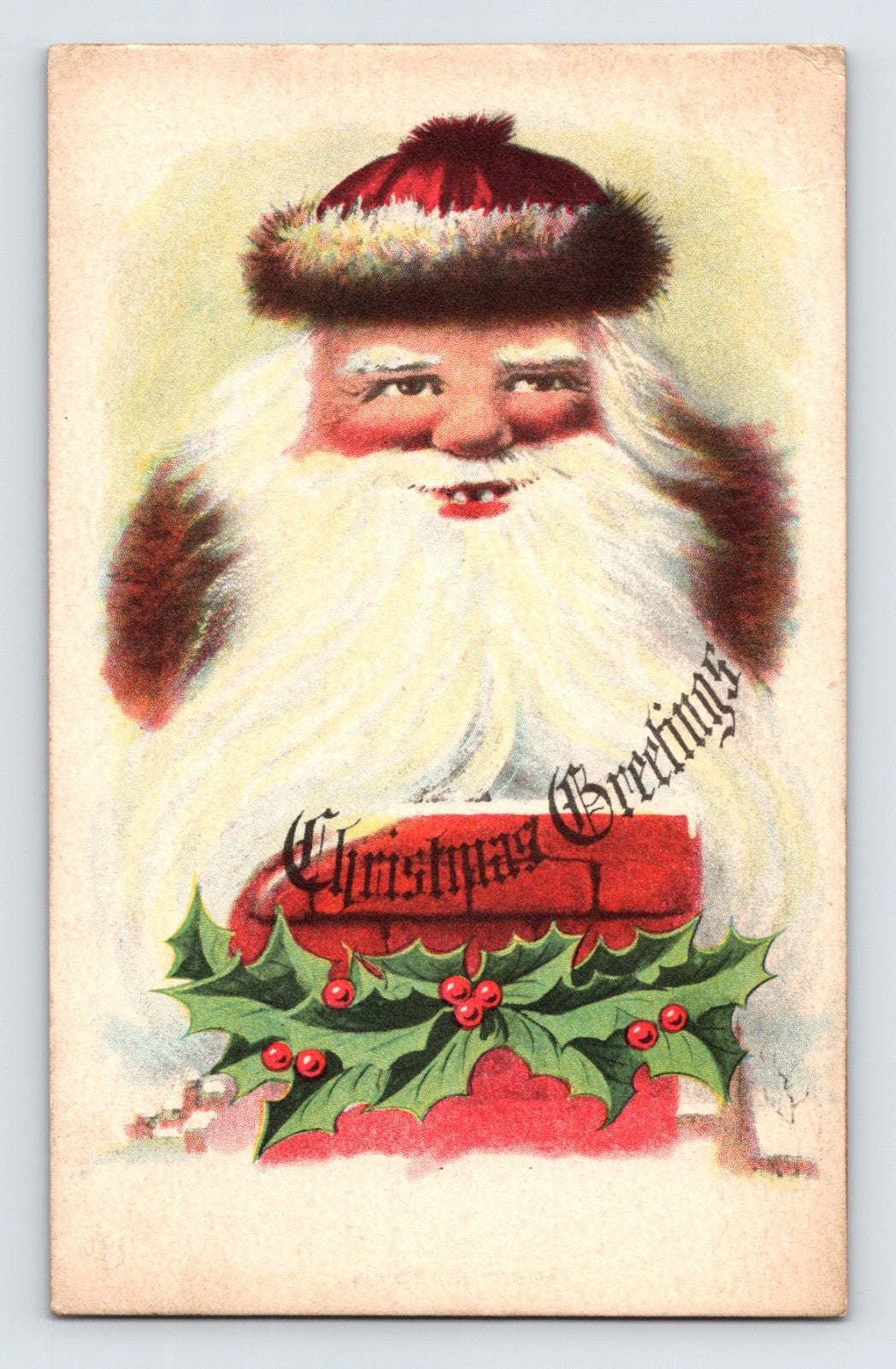 Large smiling Santa Claus portrait with holly leaves and berries surrounding a Christmas Greetings banner in an early twentieth-century holiday postcard design.