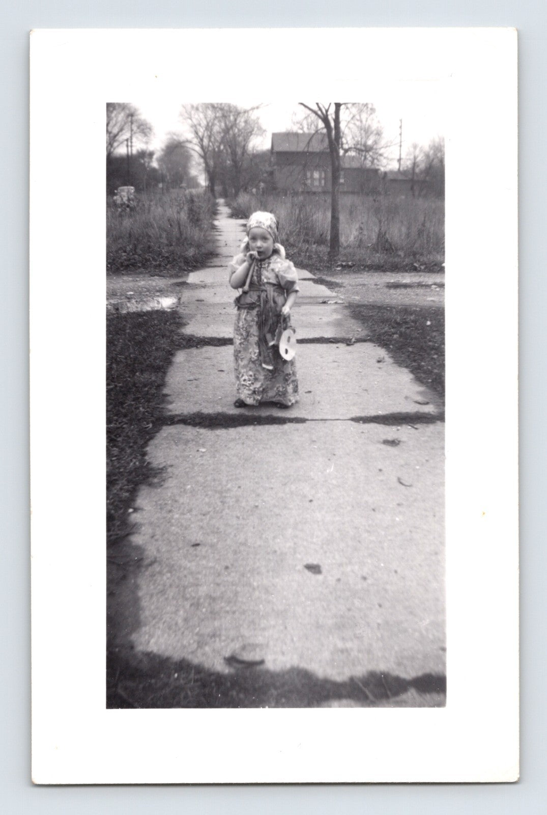 Halloween child costume sidewalk snapshot mask toy 1960s black and white photo