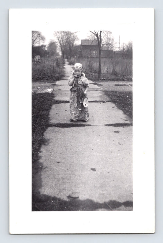 Halloween child costume sidewalk snapshot mask toy 1960s black and white photo