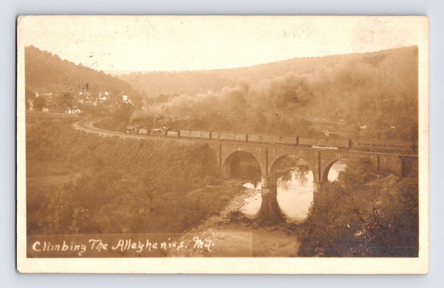 Maryland Allegheny Mountains railroad train crossing multi-arch stone bridge over river, real photo postcard circa 1916