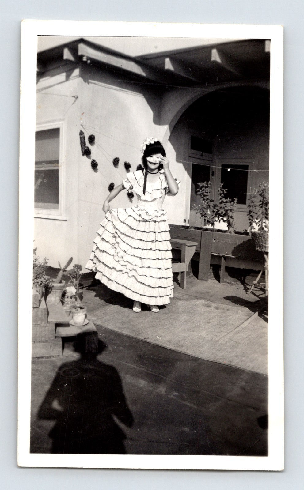 Girl Halloween costume ruffled dress mask patio mid century home black and white snapshot
