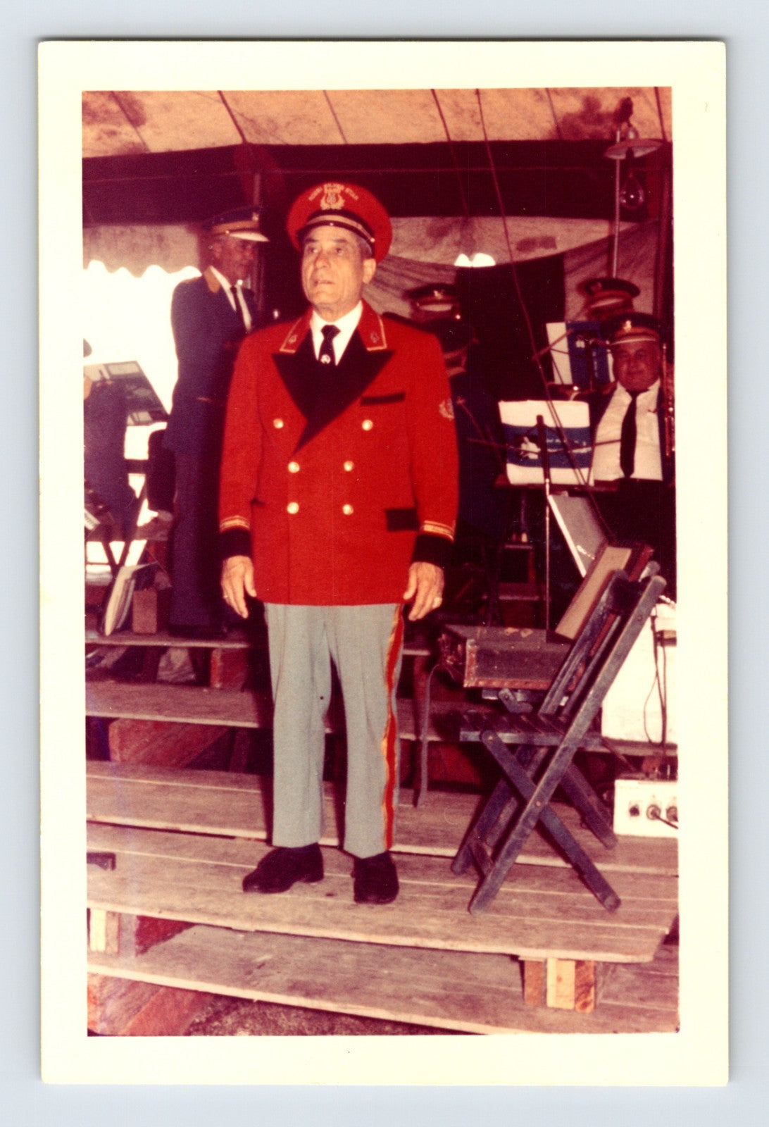 Mills Bros Circus 1960s band leader in red uniform standing on bandstand inside circus tent photograph