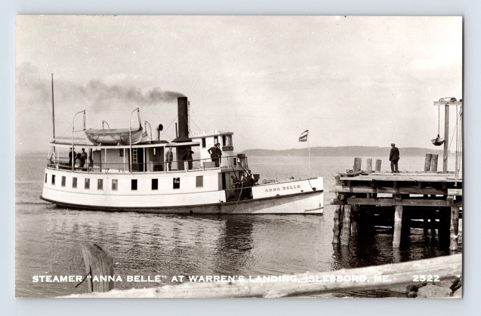 Black-and-white real photo postcard showing the steamer Anna Belle approaching Warren’s Landing dock at Islesboro, Maine.