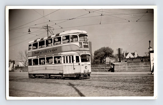 British double deck tram Route 21 West Island Phillips Sports advert cobbled street 1930s