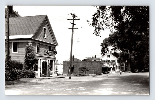 Unity Maine Main Street Rexall Drugs storefront 1950s RPPC small town buildings street view