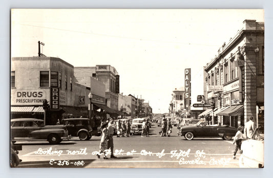 Sepia postcard view of Fifth Street downtown Eureka California with Daly’s sign and street traffic 1950s