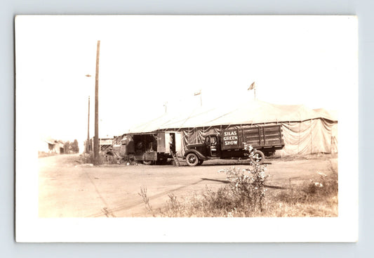 Silas Green Show circus tent and lettered truck parked on open lot with canvas big top and utility pole, 1937 photograph