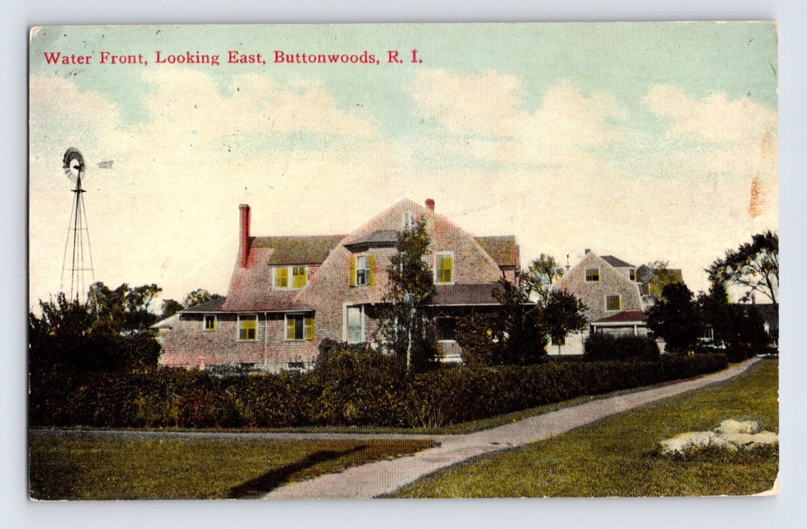 1914 postcard of waterfront homes in Buttonwoods Rhode Island showing coastal houses windmill and sheep along a curved path near the shoreline