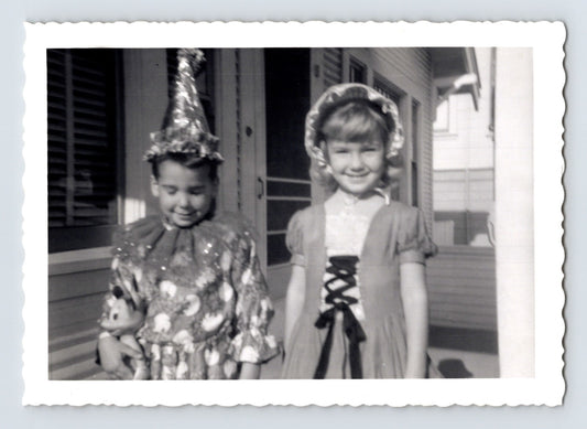 Two girls Halloween costumes porch party hat dress doll 1950s black and white snapshot