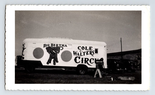 Black and white photograph of Cole Walters Circus elephant trailer marked Big Bertha in Hugo Oklahoma with circus vehicles parked nearby