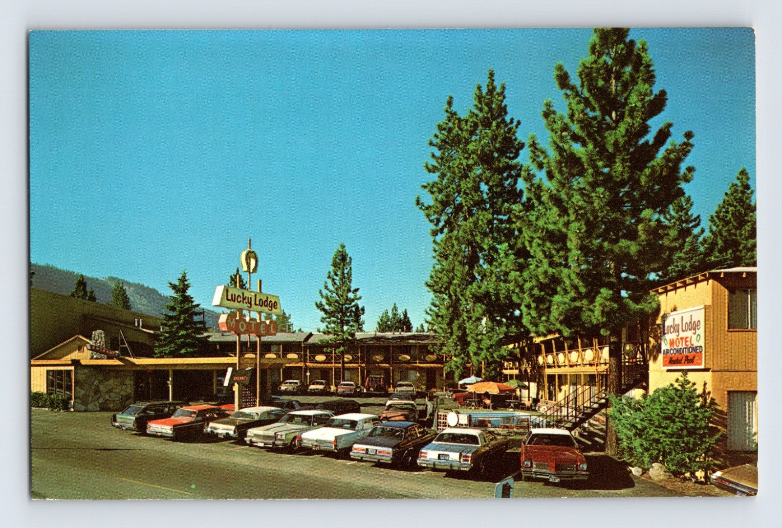 South Lake Tahoe California Lucky Lodge Motel parking lot scene 1960s postcard chrome unposted