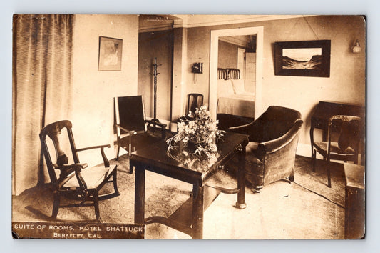 Vintage black and white photo of a hotel room interior with furniture and decor.