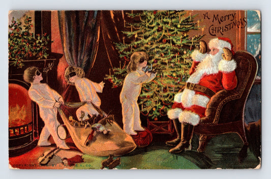 Children in white nightgowns point toy pistols at Santa Claus beside a decorated Christmas tree in an unusual early twentieth-century holiday postcard scene.
