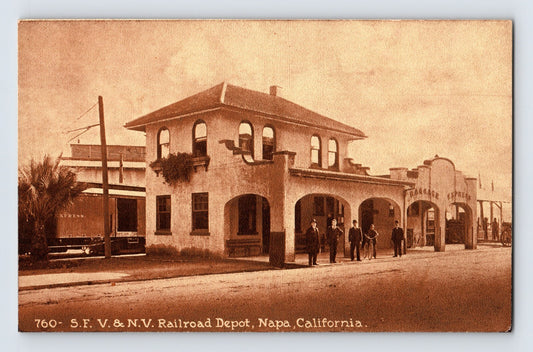 Sepia postcard showing S F V and N V Railroad Depot in Napa, California, with arched façade, train car at left, and men standing on platform; divided back format.