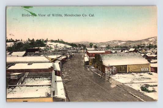 Birds-eye view of downtown Willits California with snow-covered streets and Rainier Beer sign 1910 posted postcard