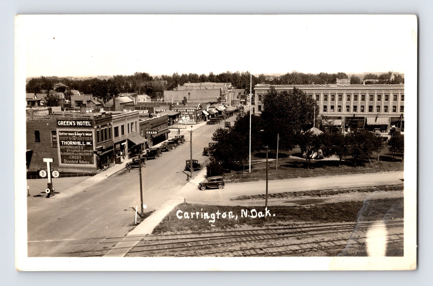 Carrington North Dakota downtown street view railroad tracks automobiles real photo postcard 1940s