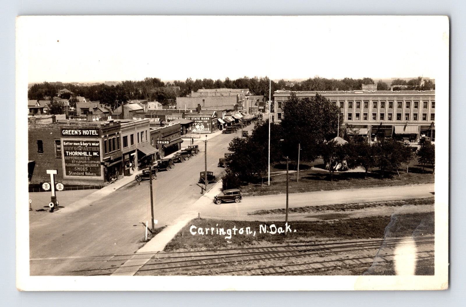 Carrington North Dakota downtown street view railroad tracks automobiles real photo postcard 1940s