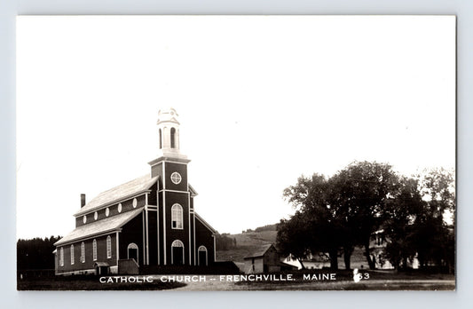 Catholic Church building with steeple and adjacent trees in Frenchville, Maine, 1950s real photo postcard.