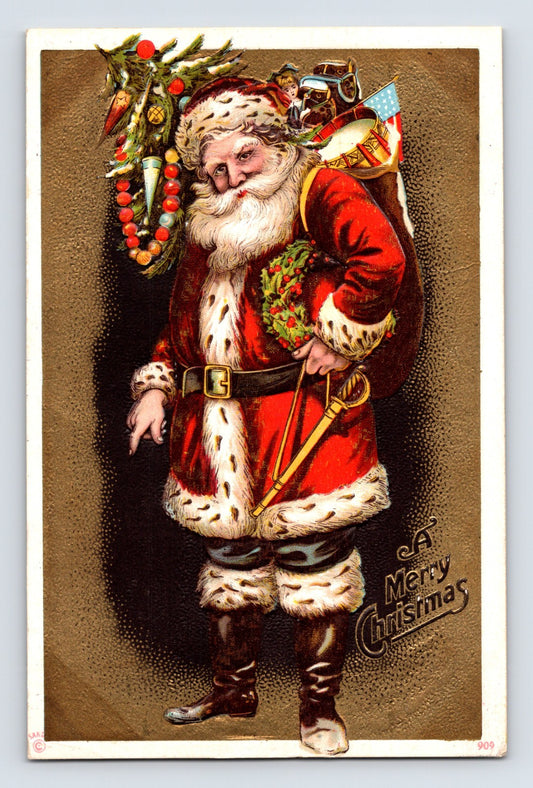 Santa Claus with holly wreath, drum, toy automobile, and American flag standing against a metallic gold background on this embossed Christmas postcard.