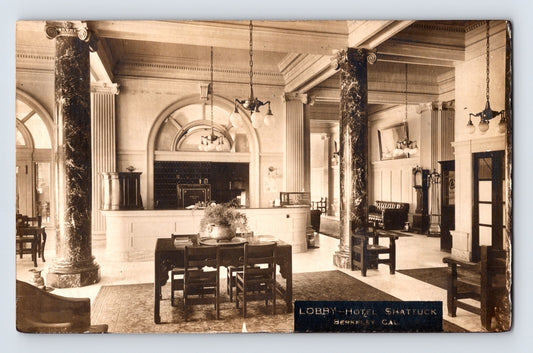 Sepia interior view of Hotel Shattuck lobby with marble columns and reception desk in Berkeley California 1910s RPPC